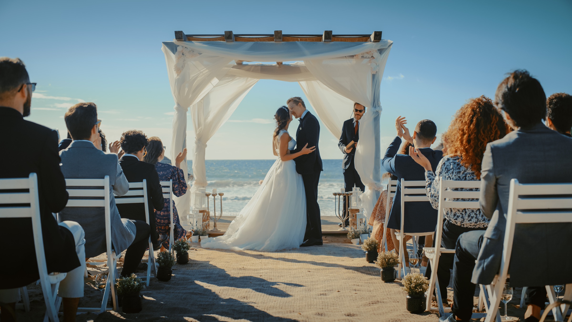 Mae and Elliot exchanging vows beside the water